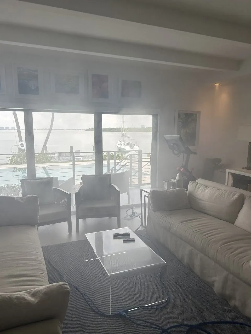 Living room with treatment vapor and a hose running to the equipment
