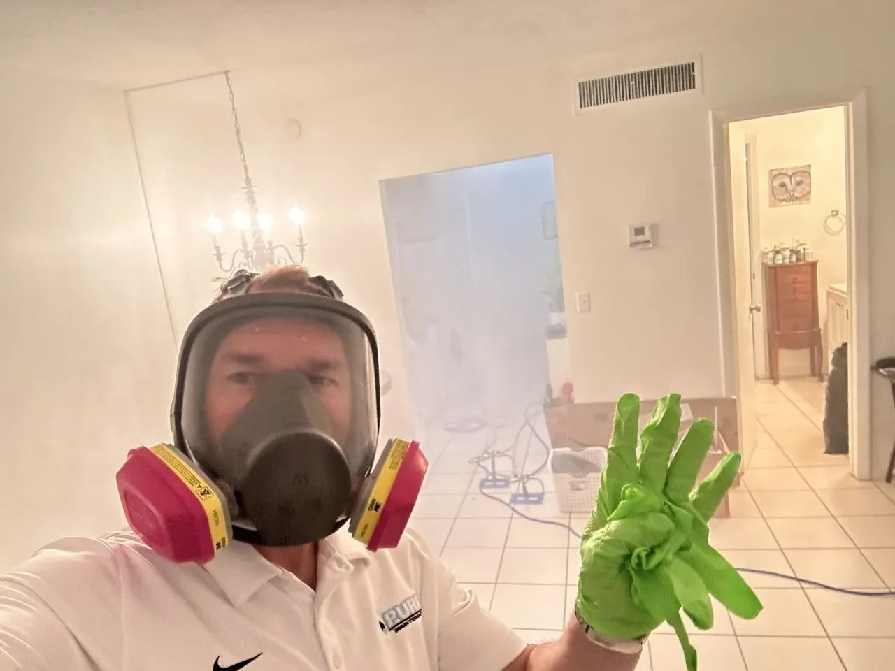 Pure Maintenance Mold Removal technician in a respirator during a treatment in a Palm Beach County home