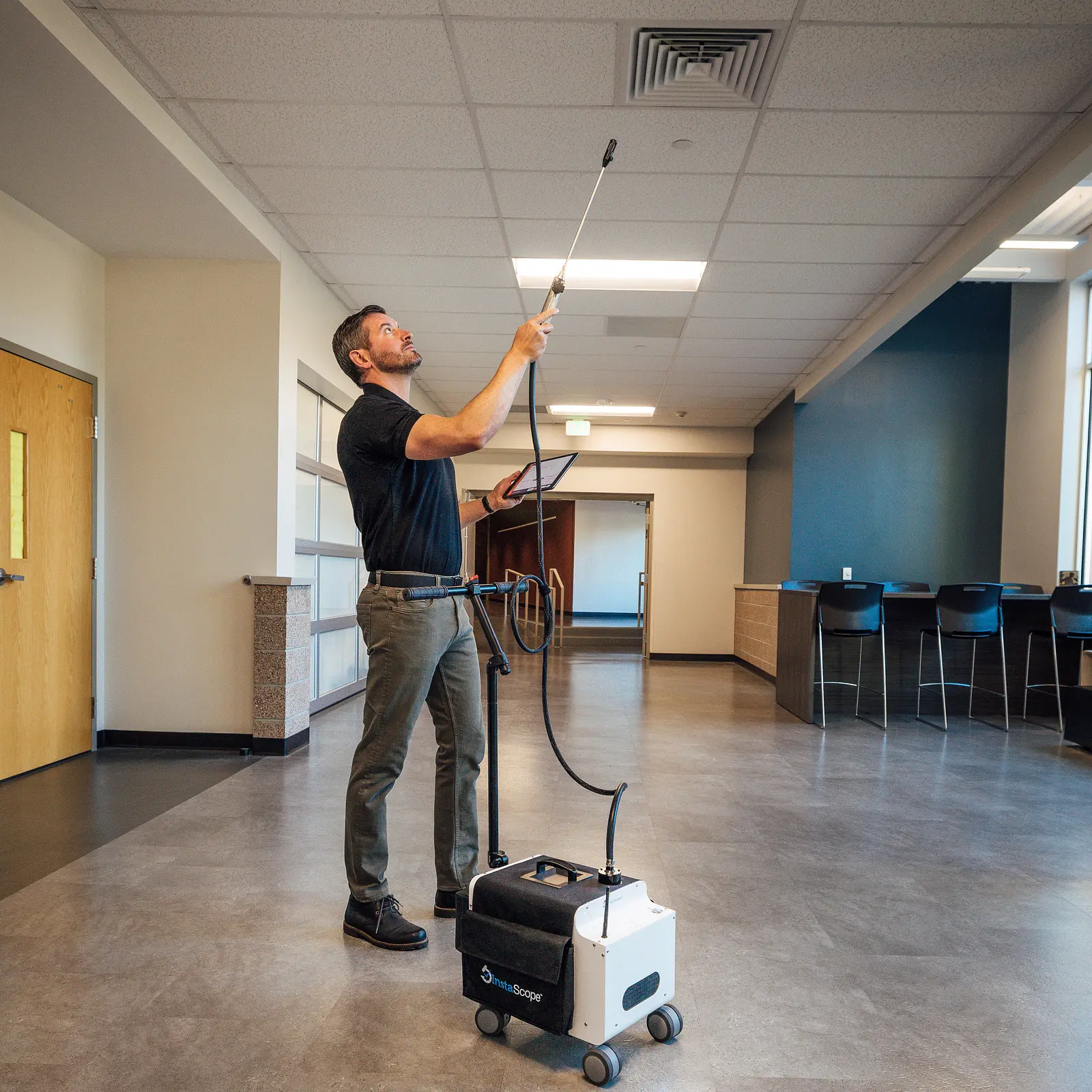 Pure Maintenance Mold Removal technician scanning a ceiling vent with the InstaScope wand